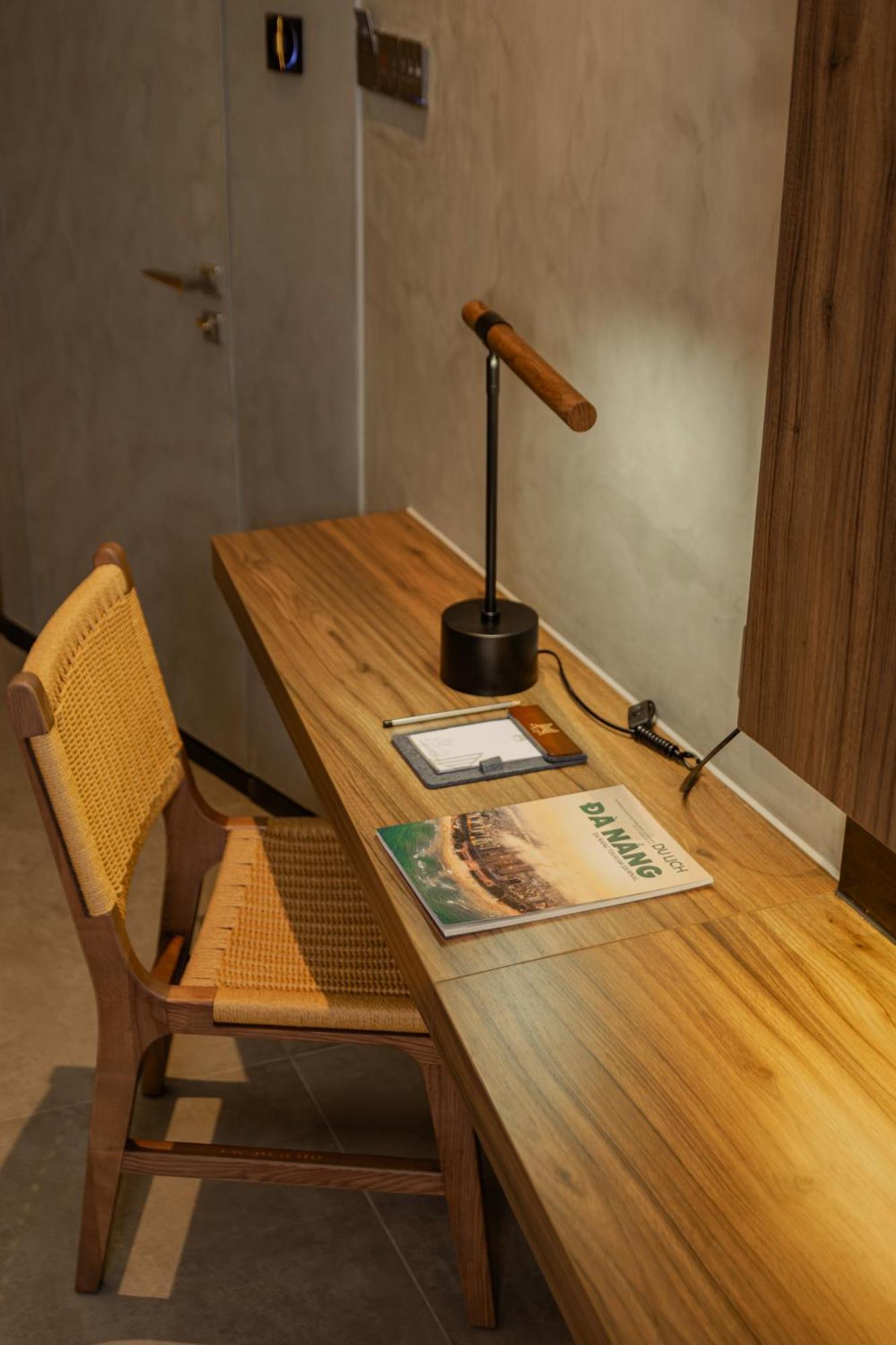 M Hotel Danang Eksteriør billede A desk with a magazine on it